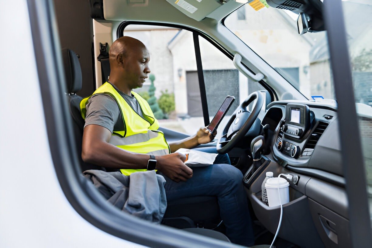 African-American Man Using Tablet in Delivery Van