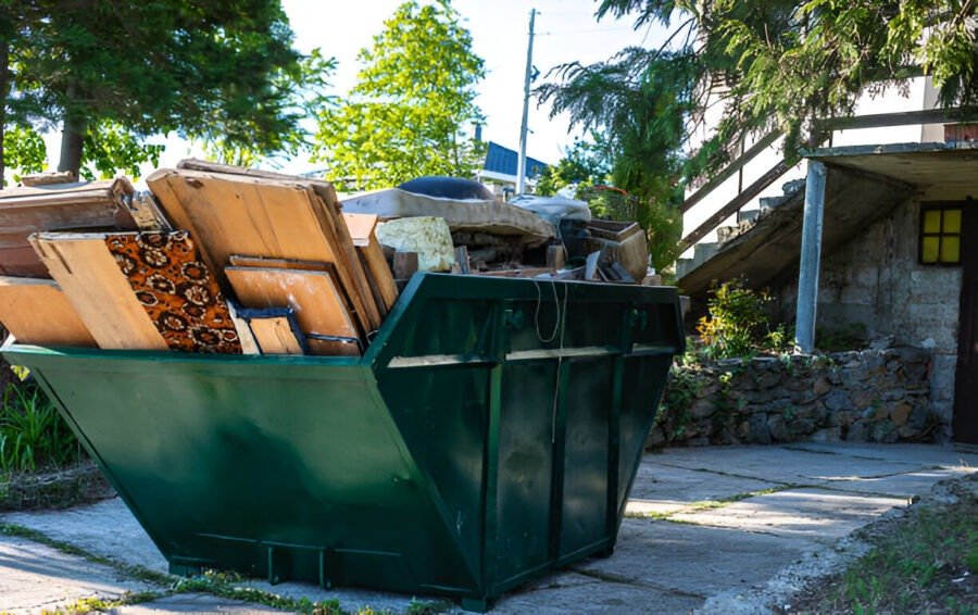 Green dumpster filled with construction debris, symbolizing local junk removal services.