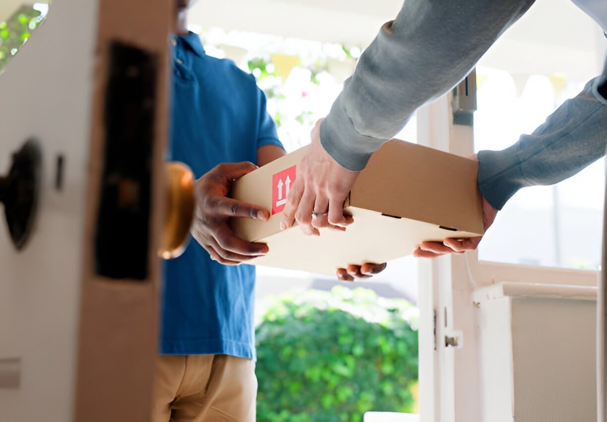 Hands, box and delivery man at front door in home with client