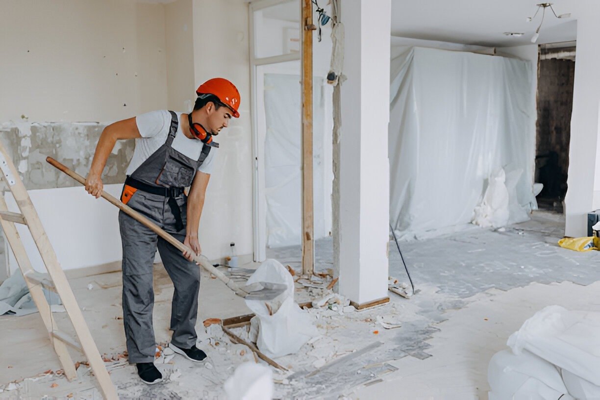 Construction worker cleaning debris during post-construction clean-up