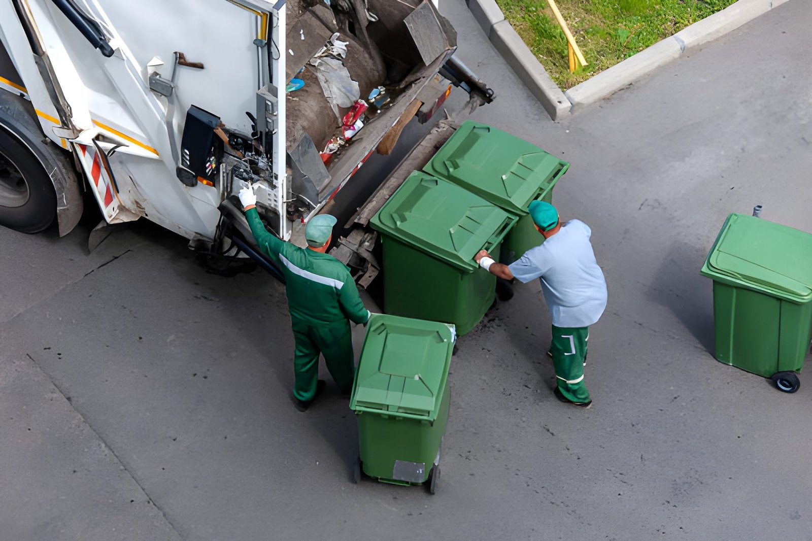 garbage men loading household rubbish in garbage truck